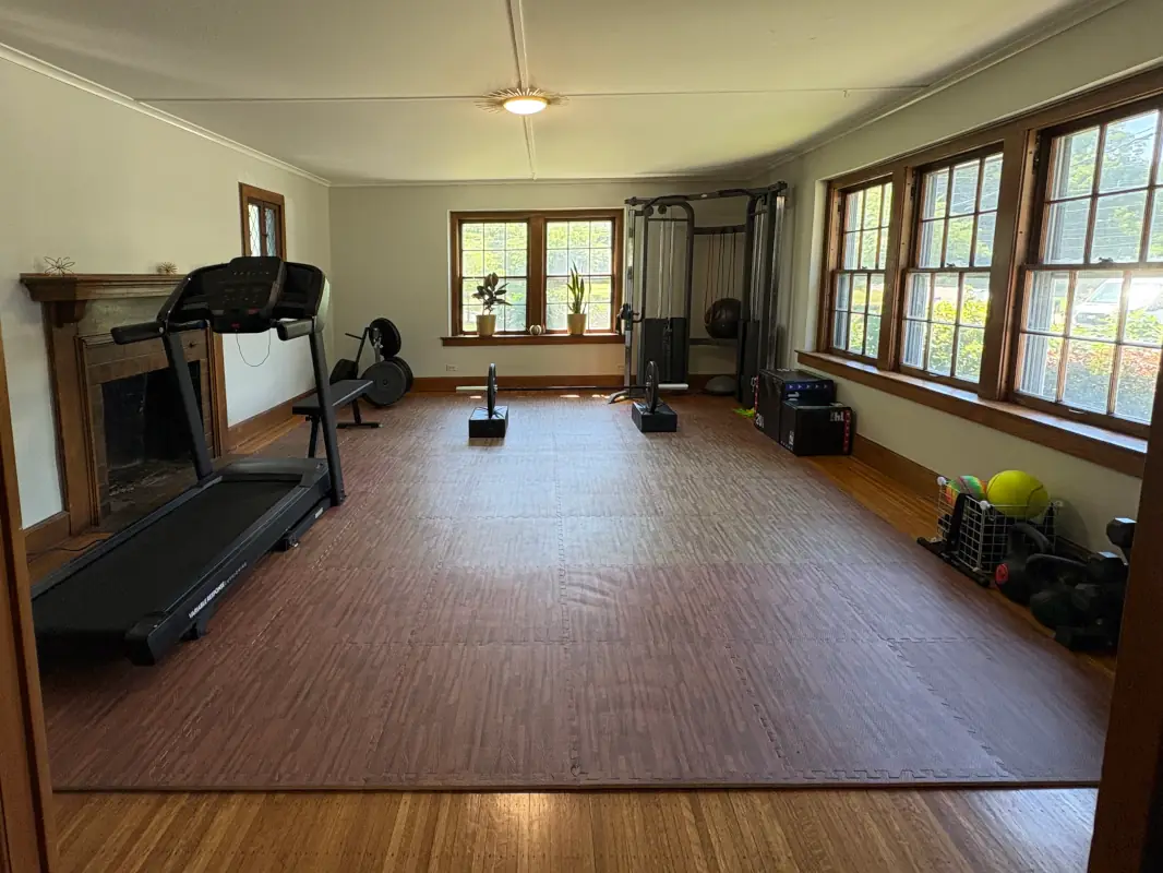 Our modern and private rehabilitation equipment room - weight machine, treadmill, weights, exercise balls and more